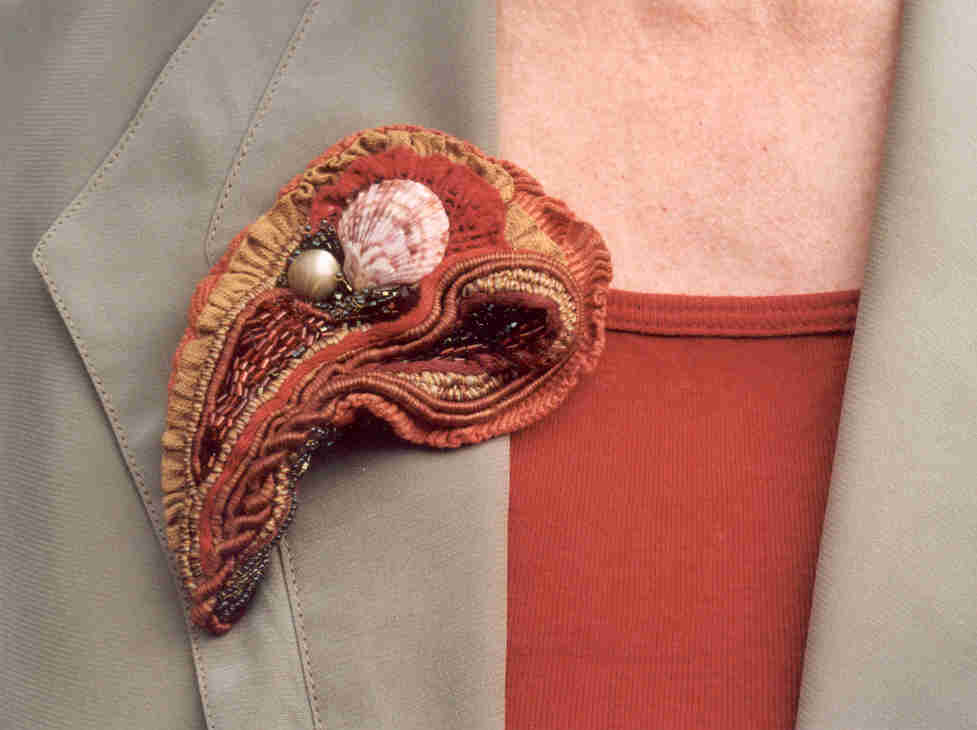 brooch : fabrics, shell, mother of pearl, glass beads